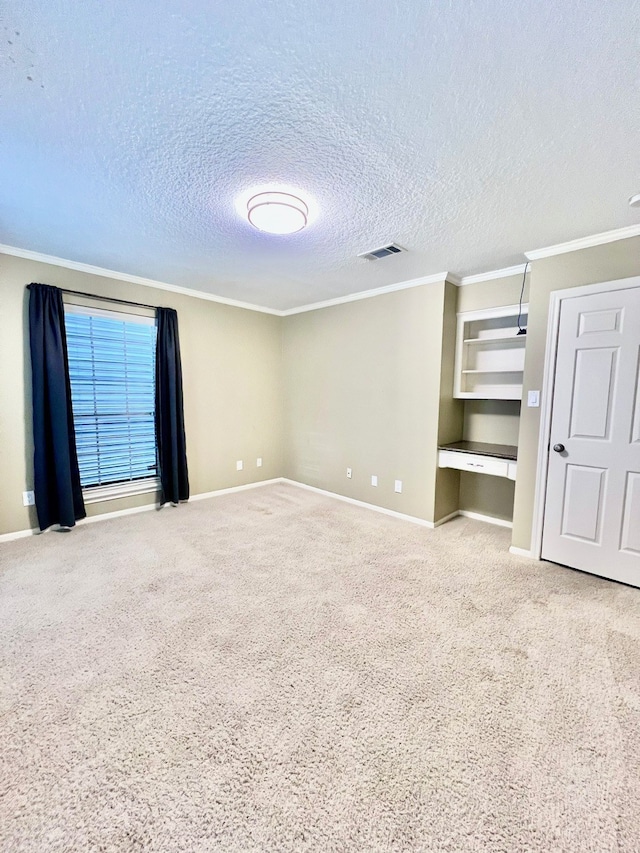 unfurnished bedroom with ornamental molding, carpet flooring, and a textured ceiling