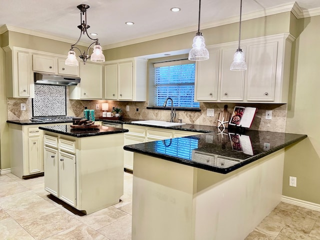 kitchen with sink, white cabinetry, hanging light fixtures, kitchen peninsula, and a kitchen island