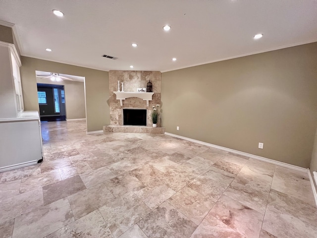 unfurnished living room featuring ceiling fan, ornamental molding, and a fireplace