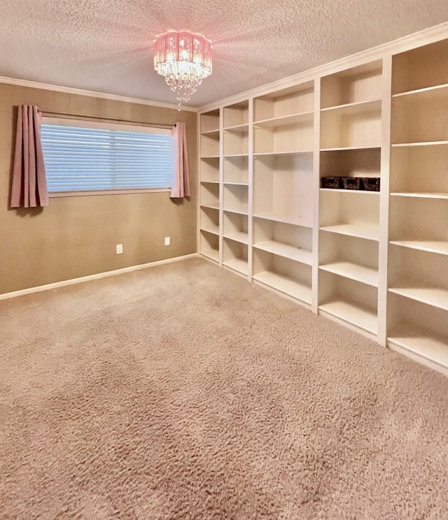 empty room with a chandelier, a textured ceiling, and carpet flooring