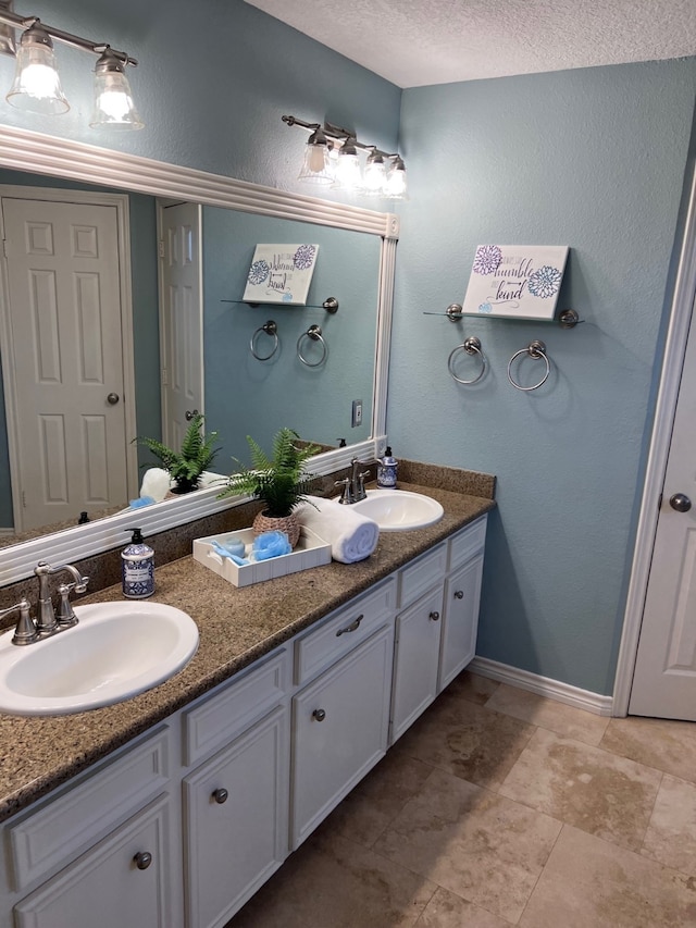 bathroom featuring vanity and a textured ceiling