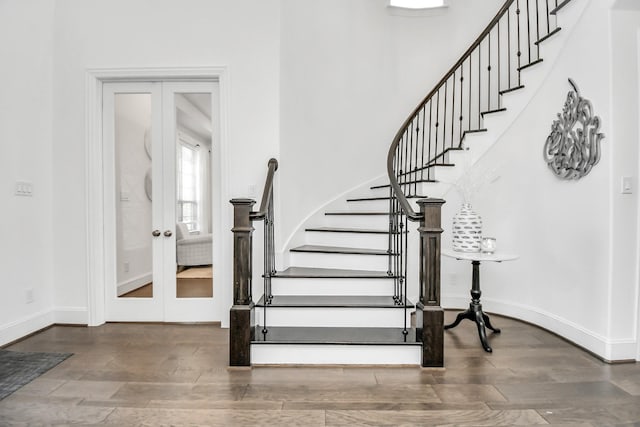 staircase with french doors and wood-type flooring