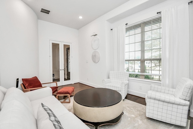 living room with french doors and dark hardwood / wood-style floors