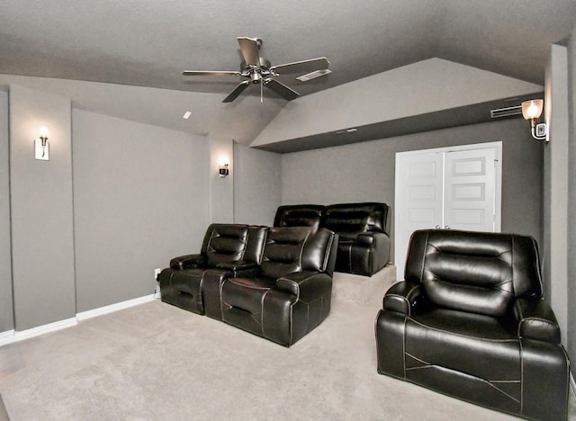 carpeted cinema room with ceiling fan and lofted ceiling