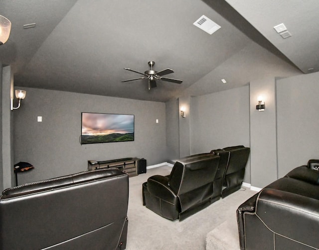 cinema with ceiling fan, lofted ceiling, and carpet flooring