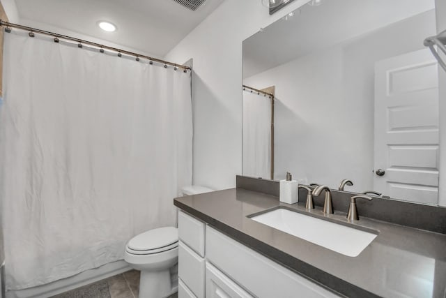 bathroom featuring vanity, toilet, and walk in shower