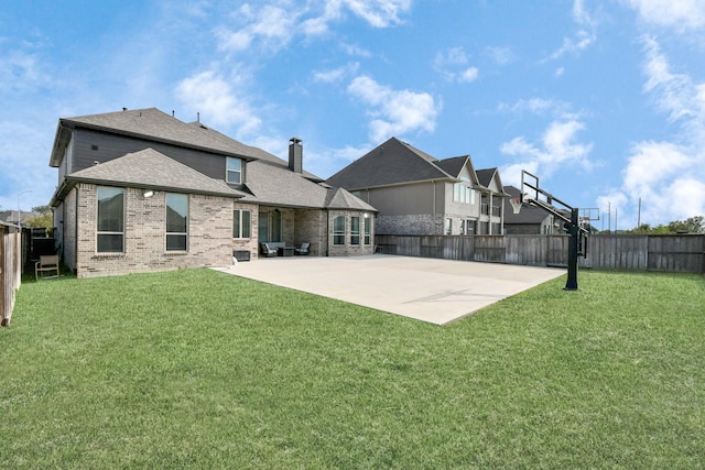 back of property featuring basketball court, a yard, and a patio