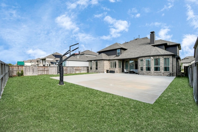 back of house featuring basketball court and a lawn