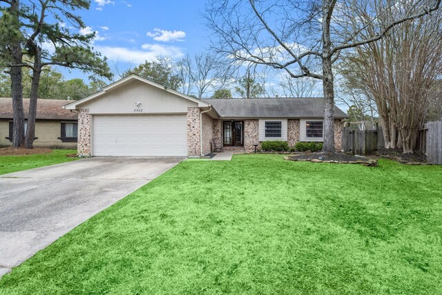 single story home featuring a garage and a front yard