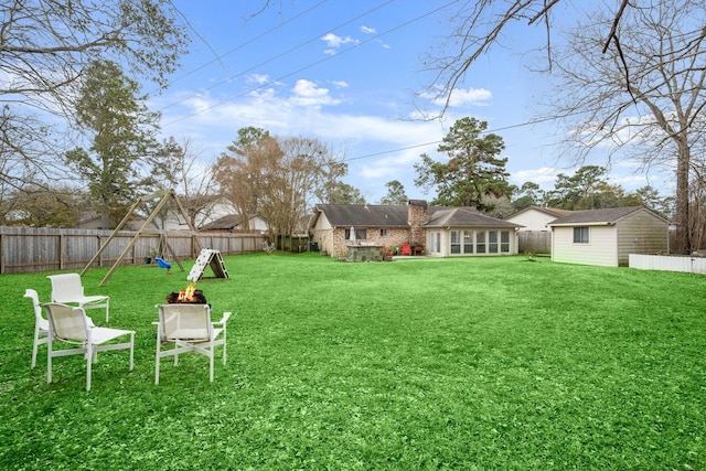 view of yard with an outdoor structure and a playground