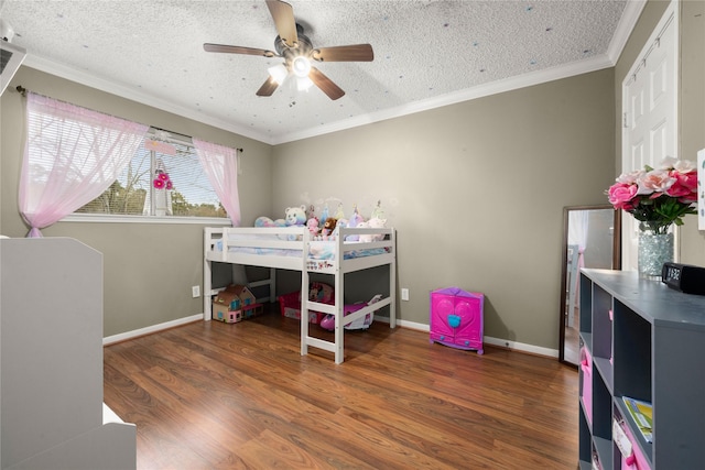 bedroom with crown molding, ceiling fan, dark hardwood / wood-style floors, and a textured ceiling