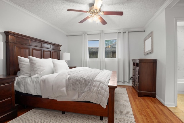 bedroom featuring crown molding, light hardwood / wood-style flooring, ensuite bath, and a textured ceiling