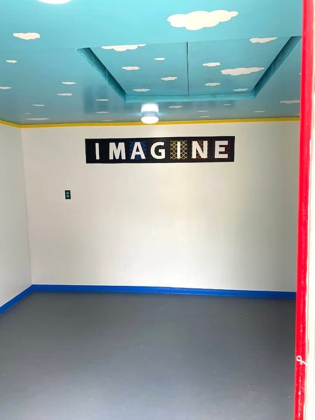 interior space with concrete flooring and baseboards