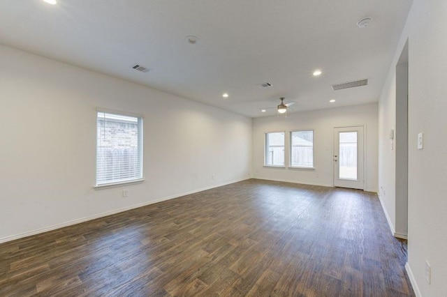 empty room featuring dark wood-type flooring and ceiling fan