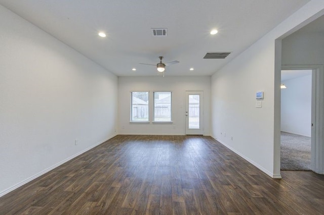 spare room with dark hardwood / wood-style floors and ceiling fan