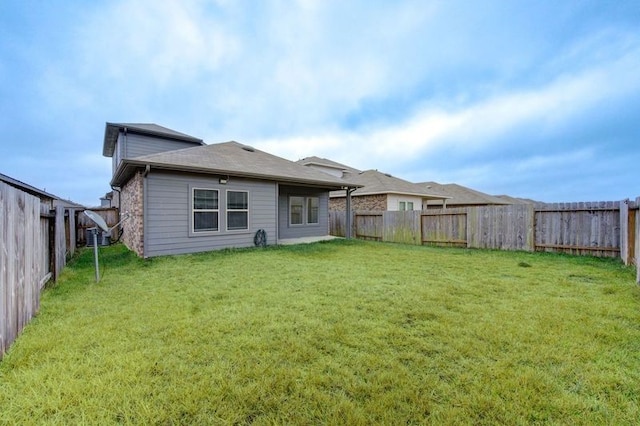 rear view of property featuring a yard