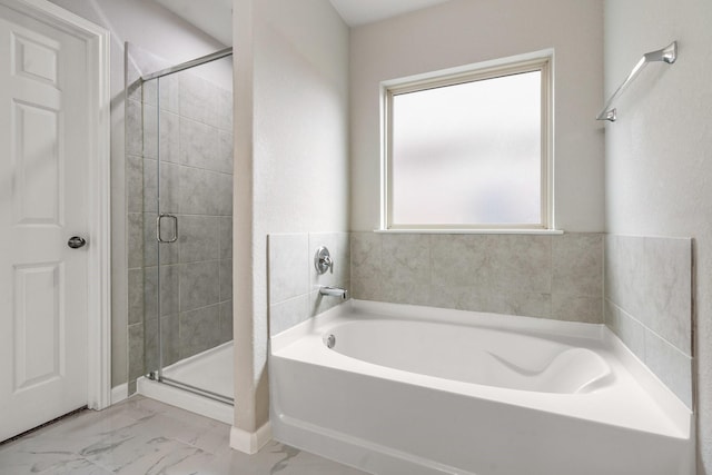 bathroom featuring separate shower and tub