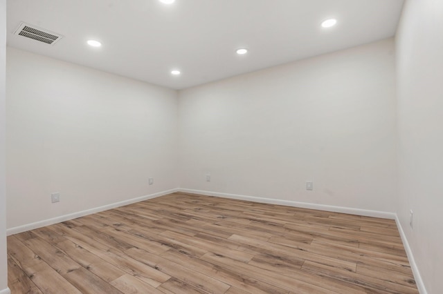 empty room with light hardwood / wood-style flooring