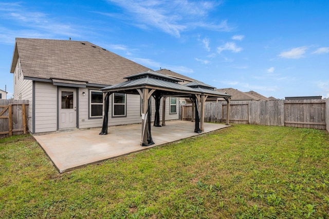 rear view of house with a lawn, a patio area, and a gazebo