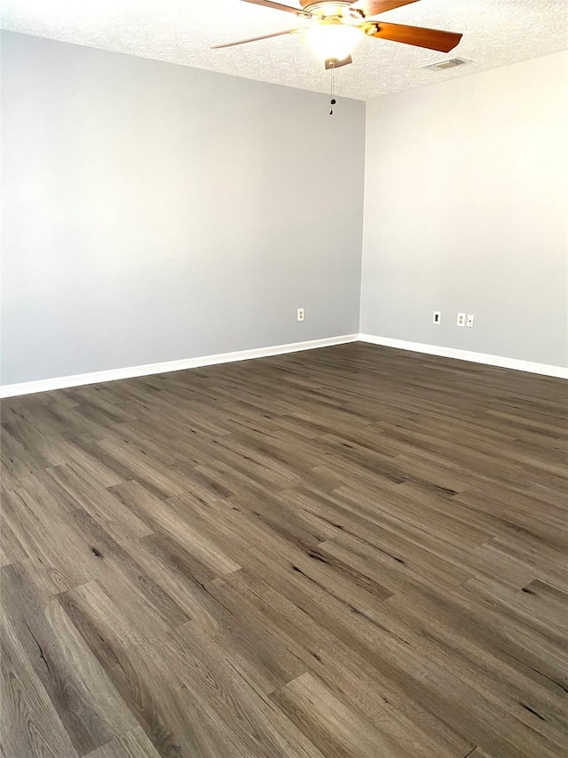 unfurnished room featuring ceiling fan, dark hardwood / wood-style flooring, and a textured ceiling