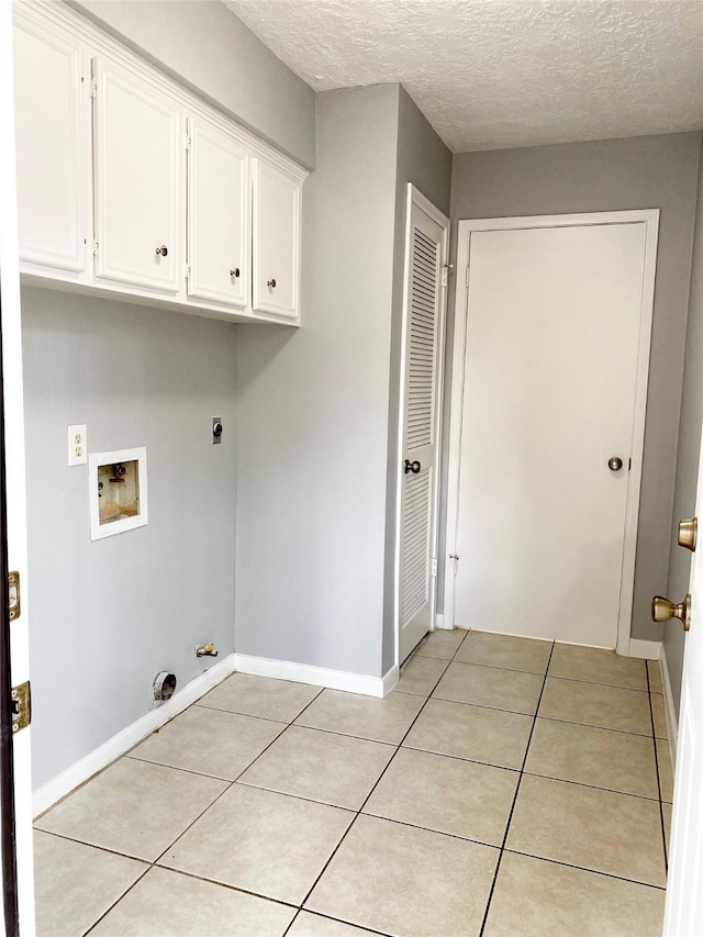 washroom featuring a textured ceiling, light tile patterned floors, electric dryer hookup, washer hookup, and hookup for a gas dryer