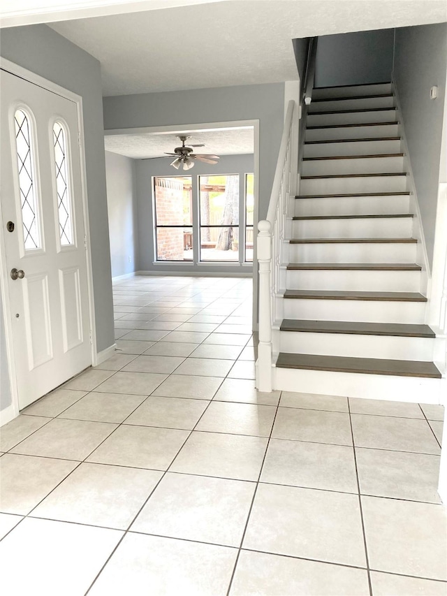 entryway with light tile patterned flooring and ceiling fan