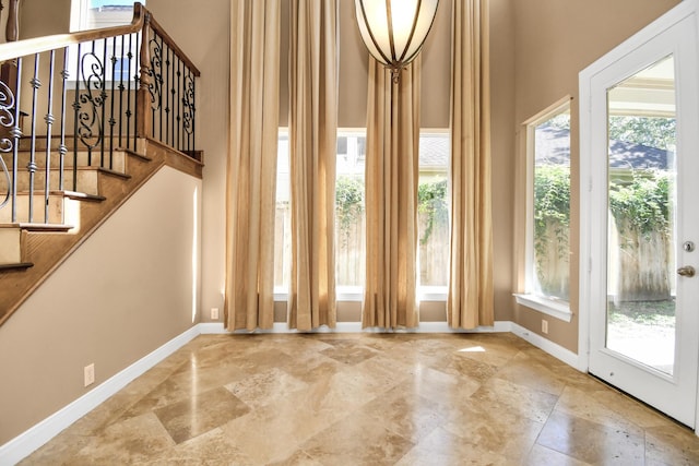 entryway with a wealth of natural light and a high ceiling