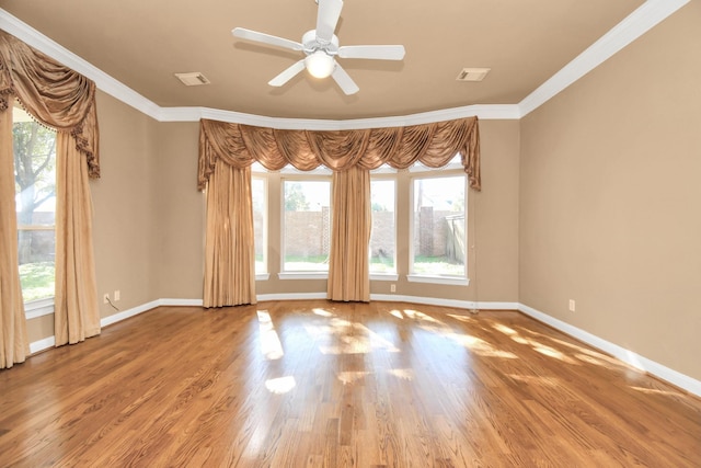 empty room with hardwood / wood-style floors, crown molding, and ceiling fan