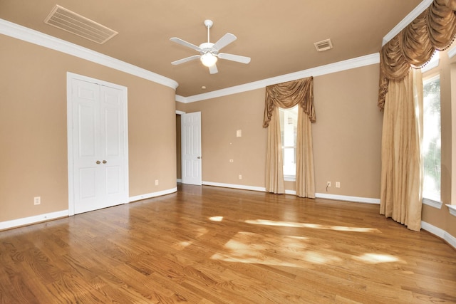 unfurnished room with crown molding, ceiling fan, and wood-type flooring