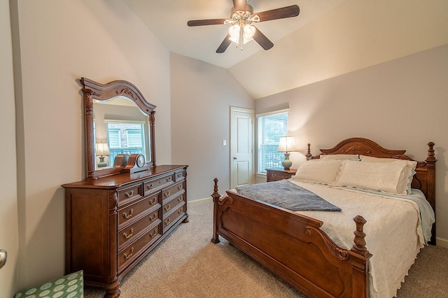 carpeted bedroom with multiple windows, vaulted ceiling, and ceiling fan