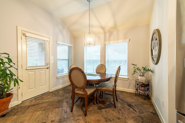 dining space with vaulted ceiling, a chandelier, and a healthy amount of sunlight