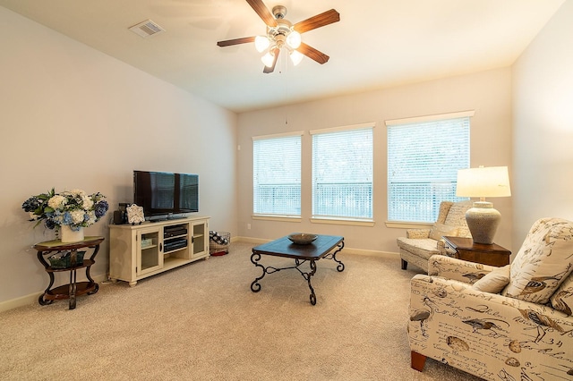 living room with ceiling fan and light colored carpet