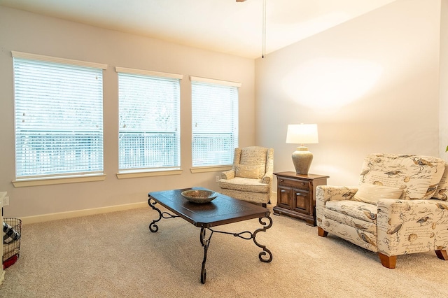 sitting room with a wealth of natural light and light colored carpet