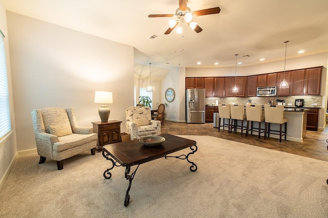 living room featuring dark colored carpet and ceiling fan