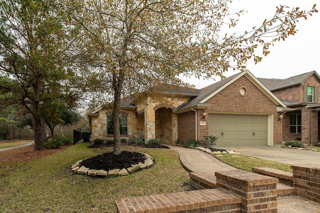 view of front of property featuring a garage and a front lawn