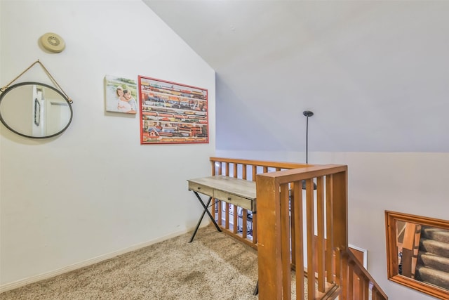 hallway featuring lofted ceiling and carpet