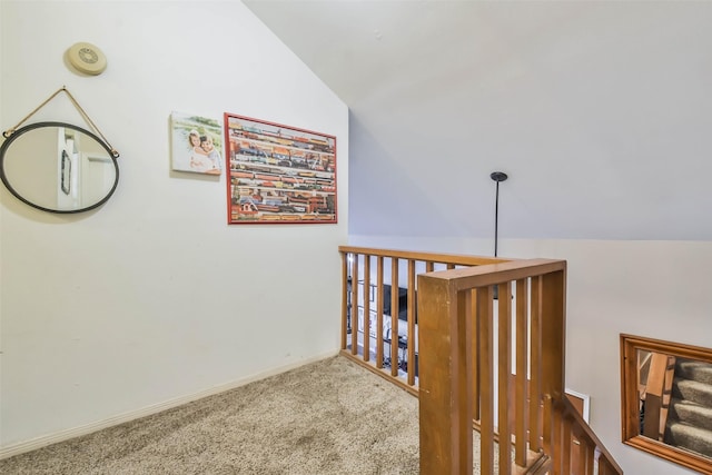 corridor featuring vaulted ceiling and carpet