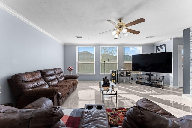 living room featuring crown molding, ceiling fan, and a textured ceiling