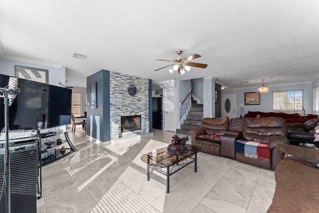 living room featuring a fireplace, ornamental molding, and ceiling fan