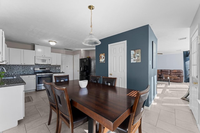 dining room with light tile patterned flooring and sink