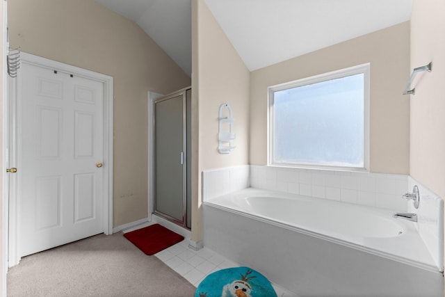 bathroom with tile patterned floors, separate shower and tub, and vaulted ceiling