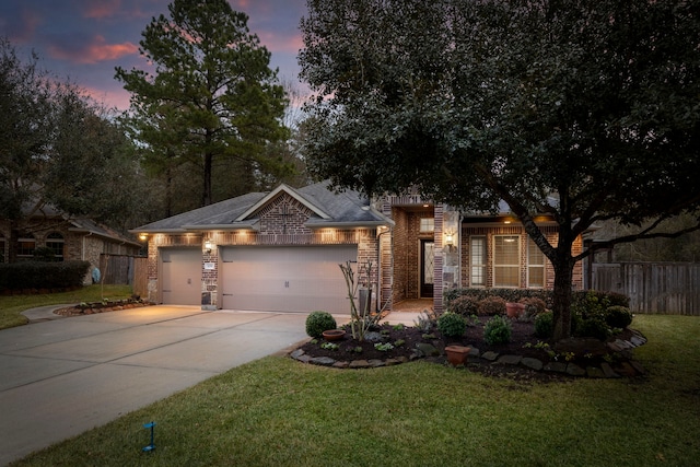 view of front of property featuring a garage and a yard