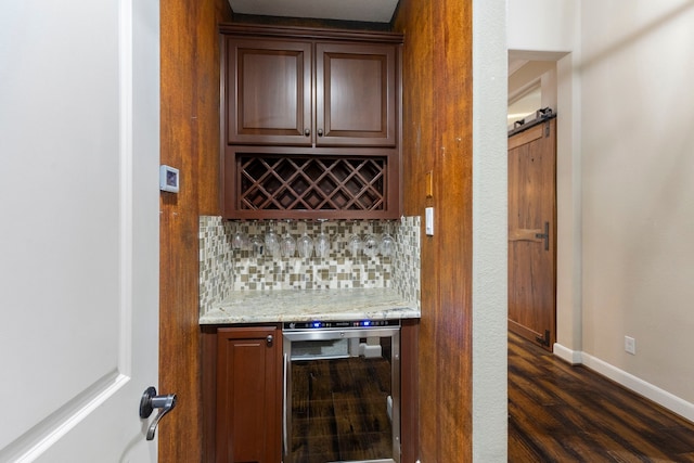 bar featuring wine cooler, dark hardwood / wood-style flooring, light stone countertops, and tasteful backsplash