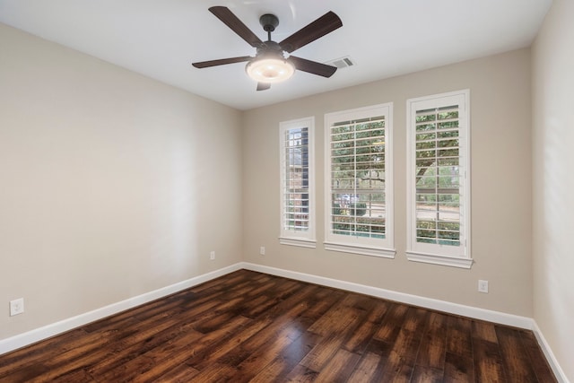 spare room with dark wood-type flooring and ceiling fan