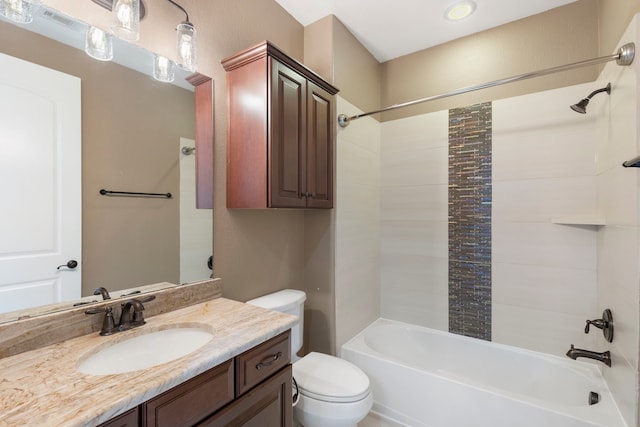 full bathroom with vanity, tiled shower / bath combo, and toilet