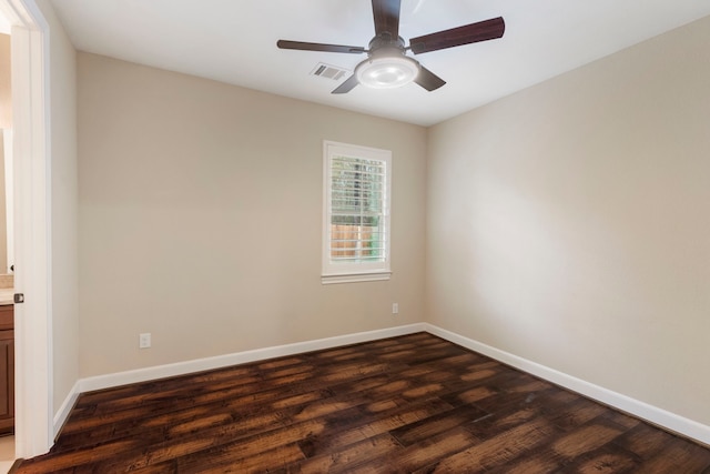 spare room featuring dark hardwood / wood-style floors and ceiling fan