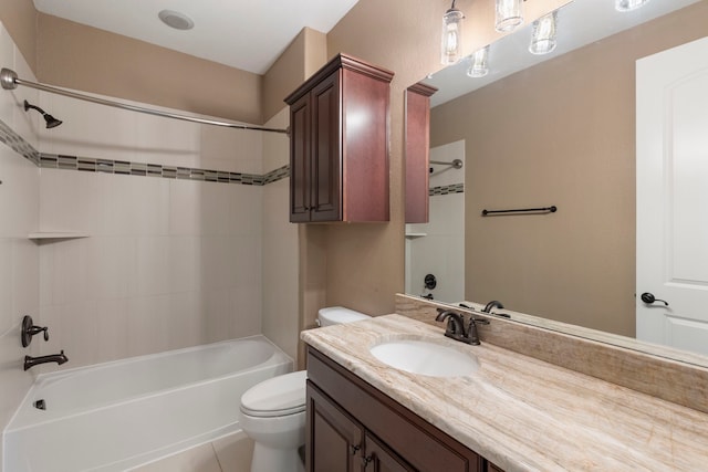 full bathroom with vanity, tiled shower / bath combo, and toilet