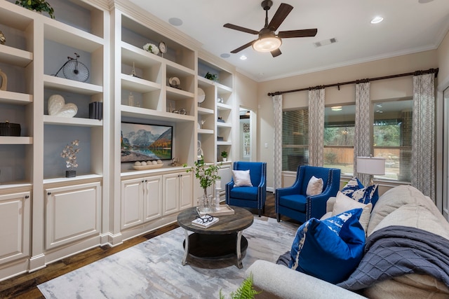 living room with dark hardwood / wood-style flooring, crown molding, and ceiling fan