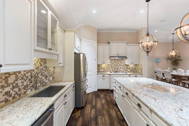 kitchen with sink, hanging light fixtures, ornamental molding, dark hardwood / wood-style flooring, and stainless steel appliances