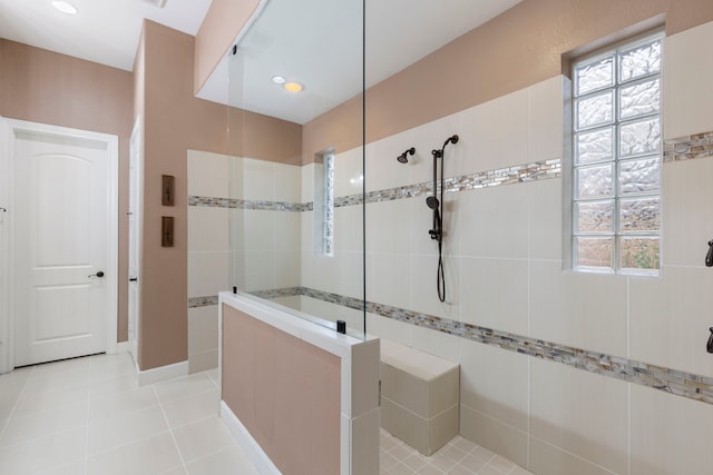 bathroom featuring tile patterned flooring and a tile shower